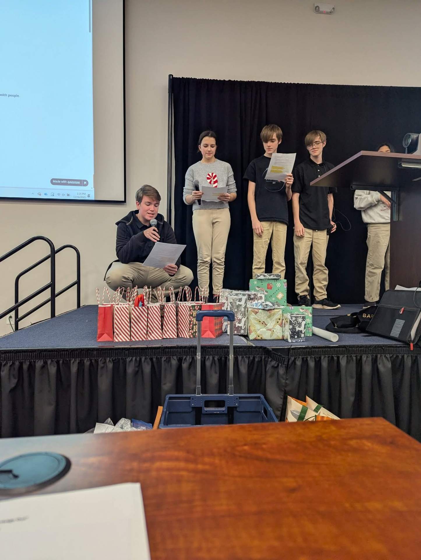 MARS students presenting on campus with microphones and prepared remarks